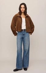 Z SUPPLY Corin Bubble Hem Jacket in Saddle Suede brown, worn by model with wide-leg jeans, front view