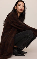 Z SUPPLY Crosby Plaid Cocoon Coat in Dark Chocolate, a long oversized brown plaid coat worn by a model crouching, styled with dark jeans and black ankle boots.