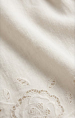 Z SUPPLY Daya Embroidered Top close-up of off-white cotton fabric with floral eyelet embroidery and scalloped hem detail