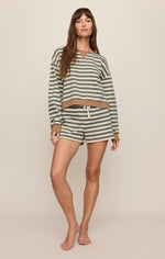 Z SUPPLY Low Key Stripe Sweatshirt in Monstera, olive green and cream stripes with tan trim, worn by model with matching shorts