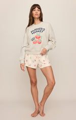 Z SUPPLY Home Grown Sweatshirt in Feather Grey with Farmer's Market tomato graphic, worn by model with printed shorts, front view.