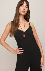 Z SUPPLY Leyla Jumpsuit in black, front view on model, featuring V-neckline, thin straps, and relaxed wide-leg silhouette.