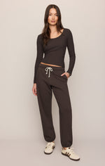 Z SUPPLY Uptown Jogger in Cocoa Bean dark brown, worn by model with matching long-sleeve top and white sneakers, front view
