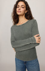 Z SUPPLY Arlet Mini Thermal Top in Monstera sage green waffle-knit fabric, model wearing front view with arms crossed, paired with jeans