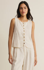 Z SUPPLY Roman Linen Vest in Cloud - model wearing cream sleeveless button-front vest with gold buttons over wide-leg pants