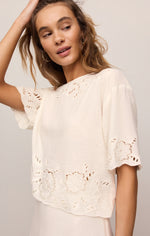 Z SUPPLY Daya Embroidered Top in white on model, featuring eyelet floral cutwork, scalloped hem, and short flutter sleeves