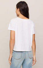 Z SUPPLY Nomad V Neck Tee in white, back view on model paired with light wash jeans, showing relaxed cropped fit