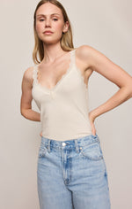 Z SUPPLY Eve Lace Tank in Sandstone, front view on model, cream V-neck camisole with scalloped lace trim, paired with light wash jeans.