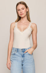 Z SUPPLY Eve Lace Tank in Sandstone, front view on model, cream V-neck cami with scalloped lace trim straps, paired with light wash jeans.