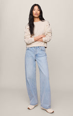 Z SUPPLY Axel Grommet Sweatshirt in Sandstone worn by model with wide-leg light wash jeans, front view showing gold grommet sleeve detail