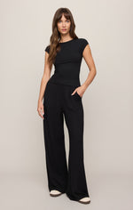 Z SUPPLY Soft Trace Second Skin Top in black, cap sleeve, boat neck, form-fitting ribbed tee styled with wide-leg pants on model, front view.