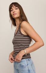 Z SUPPLY Rowe Striped Scoop Tank in Dark Chocolate with cream stripes, henley neckline, worn by model with light wash jeans, side view.
