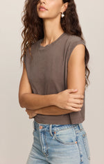 Z SUPPLY Flex Sleeveless Tee in Pebble Coast, a muted taupe-brown cropped muscle tee with ribbed hem, worn with light wash jeans.