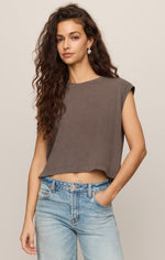 Z SUPPLY Flex Sleeveless Tee in Pebble Coast, a cropped taupe muscle tee with cap sleeves, worn by a model with light wash jeans, front view.