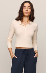 Z SUPPLY All In Henley Top in Sandstone — cropped long-sleeve ribbed top with polo collar and button placket, worn by model with navy drawstring pants.