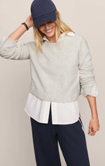 Z SUPPLY Stand In Sweater in Feather Grey layered over white collared shirt, worn by smiling model with navy cap