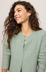 Z Supply Medina Cardigan in Mint Julep, a soft sage-green button-front knit worn by a smiling model, close-up front view.