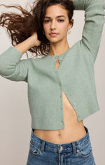 Z SUPPLY Medina Cardigan in Mint Julep, a cropped button-front knit sweater in soft sage green, worn open over jeans by a model