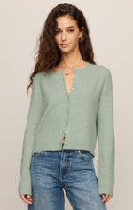 Z Supply Medina Cardigan in Mint Julep, a soft sage-green cropped knit with pearl buttons, worn by a model with blue jeans, front view.
