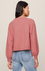 Z SUPPLY Coming Up Sweater in Desert Bloom, back view on model, cropped pink knit with raglan sleeves and ribbed cuffs paired with jeans.