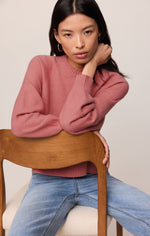 Z SUPPLY Coming Up Sweater in Desert Bloom — model wearing dusty rose crewneck knit sweater with raglan sleeves and ribbed trim, paired with light wash jeans