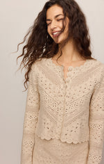 Z Supply Cressa Cardigan in Natural — model wearing cream crochet knit cardigan with scalloped hem and button front detail