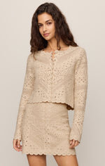 Z SUPPLY Cressa Cardigan in Natural — model wearing cropped crochet knit cardigan with scalloped hem and button front, paired with matching mini skirt