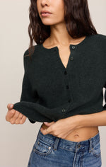 Z SUPPLY Valor Cardigan in Emerald Cove dark green, cropped fit with black buttons, worn with blue jeans, front close-up on model