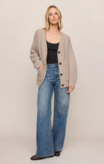 Z SUPPLY Whitmore Cardigan in light khaki, oversized ribbed knit with button front and pockets, worn by model with wide-leg jeans