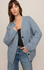 Z SUPPLY Whitmore Cardigan in Mineral Blue worn open over black top with jeans, featuring ribbed knit, button front, and relaxed oversized fit