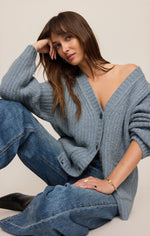 Z SUPPLY Whitmore Cardigan in Mineral Blue — model wearing oversized ribbed knit cardigan with deep V-neck and button front, seated pose