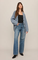 Z SUPPLY Whitmore Cardigan in Mineral Blue, oversized ribbed knit with black buttons, worn over black tank with wide-leg jeans, front view