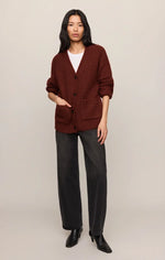 Z SUPPLY Whitmore Cardigan in Velvet Rouge, a deep rust-brown chunky knit with V-neck, button front, and patch pockets, worn by model with dark jeans.