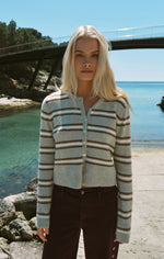 Z SUPPLY Medina Stripe Cardigan in Aqua Cloud worn by model at coastal location, featuring brown and white horizontal stripes and button front
