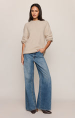 Z SUPPLY Chill Mode Sweater in Frosted Pearl, an oversized cream knit crewneck worn by a model with wide-leg blue jeans, front view.