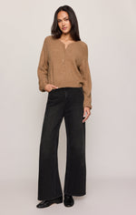 Z SUPPLY Westmont Henley Sweater in Golden Caramel, worn by model with wide-leg black jeans, front view showing henley neckline and long sleeves