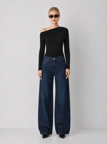 Steve Madden Ryder Knit Top in black, asymmetric one-shoulder long sleeve ruched top, worn by model with wide-leg dark denim jeans