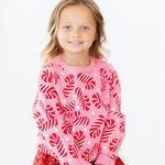 Mila Candy Canes Sweater in pink with red and white candy cane pattern, worn by young girl, front view