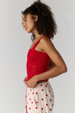 Free People Heirloom Cami in red pointelle knit with star detail, side view on model wearing polka dot pants