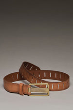 Free People WTF Jona Belt in Rustic Russet tan leather with rectangular cutout slots and antique brass buckle, flat lay
