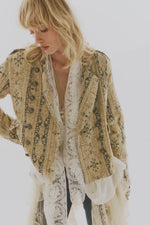 Free People Lotty Jacquard jacket in Morning Oat worn by model over white lace dress, featuring ornate pattern and double-breasted buttons