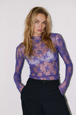 Free People Lady Lux Layering Top in Blue Beam — sheer purple lace mesh long-sleeve top worn by model with black trousers, front view
