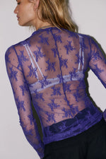 Free People Lady Lux Layering Top in Blue Beam — back view on model, sheer purple mesh with floral lace embroidery, long sleeves