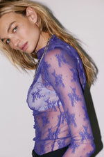 Free People Lady Lux Layering Top in Blue Beam — sheer purple lace mesh long-sleeve turtleneck with floral embroidery, worn by model