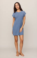 Z SUPPLY Tate Jersey Denim Mini Dress in Santorini Indigo, front view on model with raglan cap sleeves and brown strappy sandals.