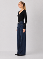 Z SUPPLY Ginger Bodysuit in black, long-sleeve with V-neckline cutout detail, worn by model with wide-leg dark denim jeans, side view
