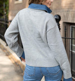 Elan Sweater Collared Denim in grey, back view on model showing knit body with blue denim collar and cuffs, paired with jeans