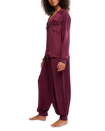 Free People Lets Sleep In Set in deep burgundy satin stripe, model wearing long-sleeve top and harem pants, side view