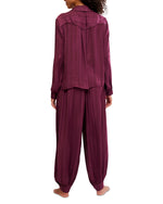 Free People Lets Sleep In Set in deep burgundy satin jacquard, back view on model showing long-sleeve top and jogger pants