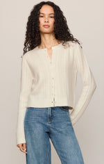 Z SUPPLY Medina Pointelle Cardigan in Cloud, a cream button-front knit cardigan with pointelle detail, worn by model with blue jeans